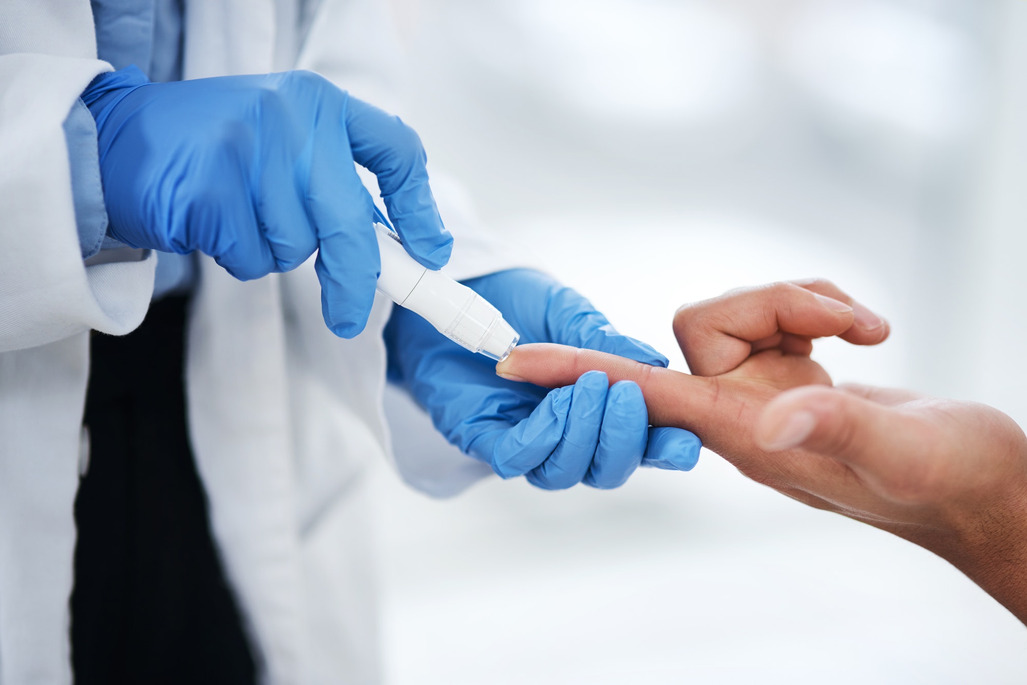 shot of an unrecognisable doctor using a blood sugar test on his patients finger.jpg